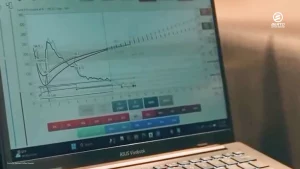 Laptop displaying coffee roast graphs from roasting software.